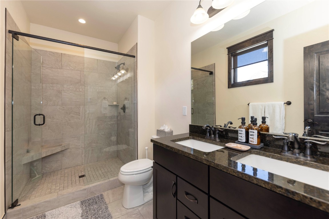 58 Erickson Loop, Unit 13A Keystone, CO 80435 - Photo 9 of 28 a bathroom with a double vanity sink toilet and shower