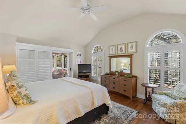 a bedroom with a bed couch and a window