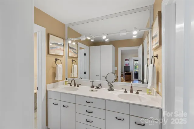 a bathroom with double sink and a mirror