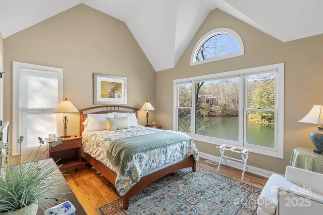a bedroom with a bed and a large window