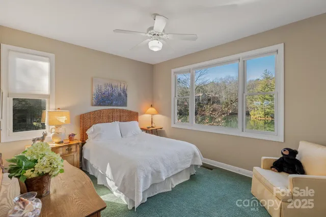 a bedroom with a bed mirror and window