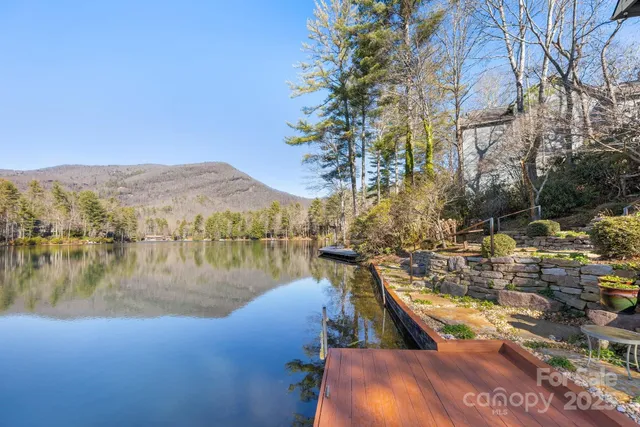 a living room with furniture and floor to ceiling windows