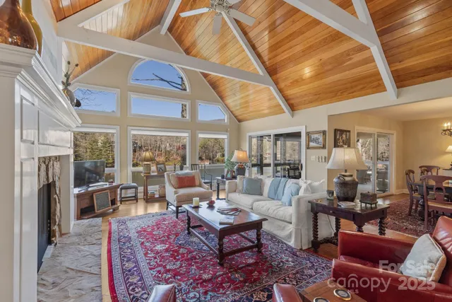 a living room with furniture a rug and a large window