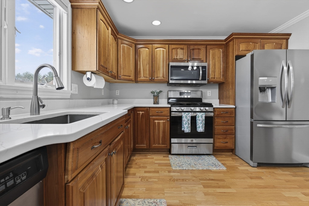 216 Rangeway Road, Unit 133 North Billerica, MA 01862 - Photo 13 of 42 a kitchen with stainless steel appliances granite countertop a refrigerator a stove a sink and a microwave