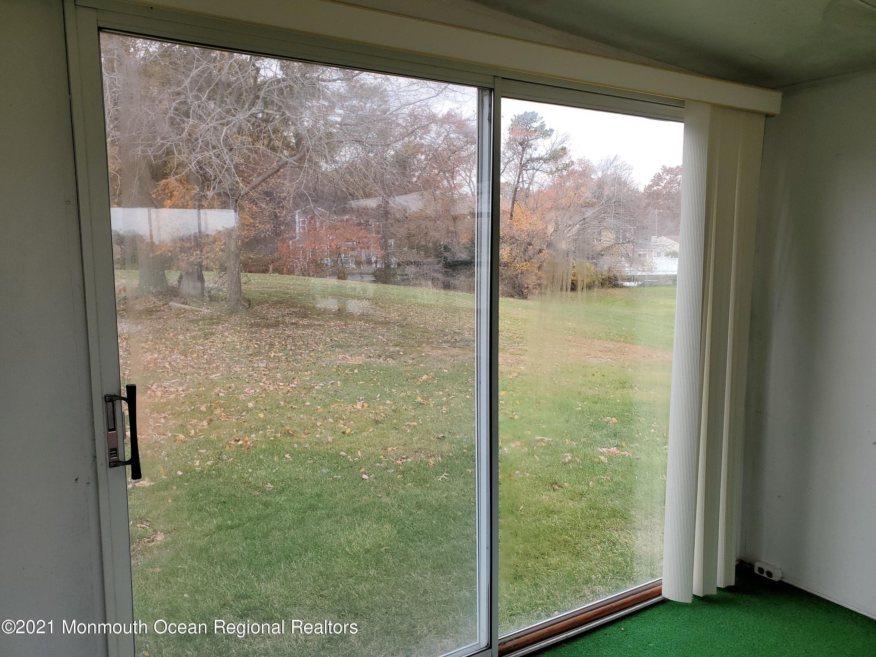 37 Patmore Road Brick, NJ 08724 - Photo 11 of 19 a view of a glass room with yard from a window