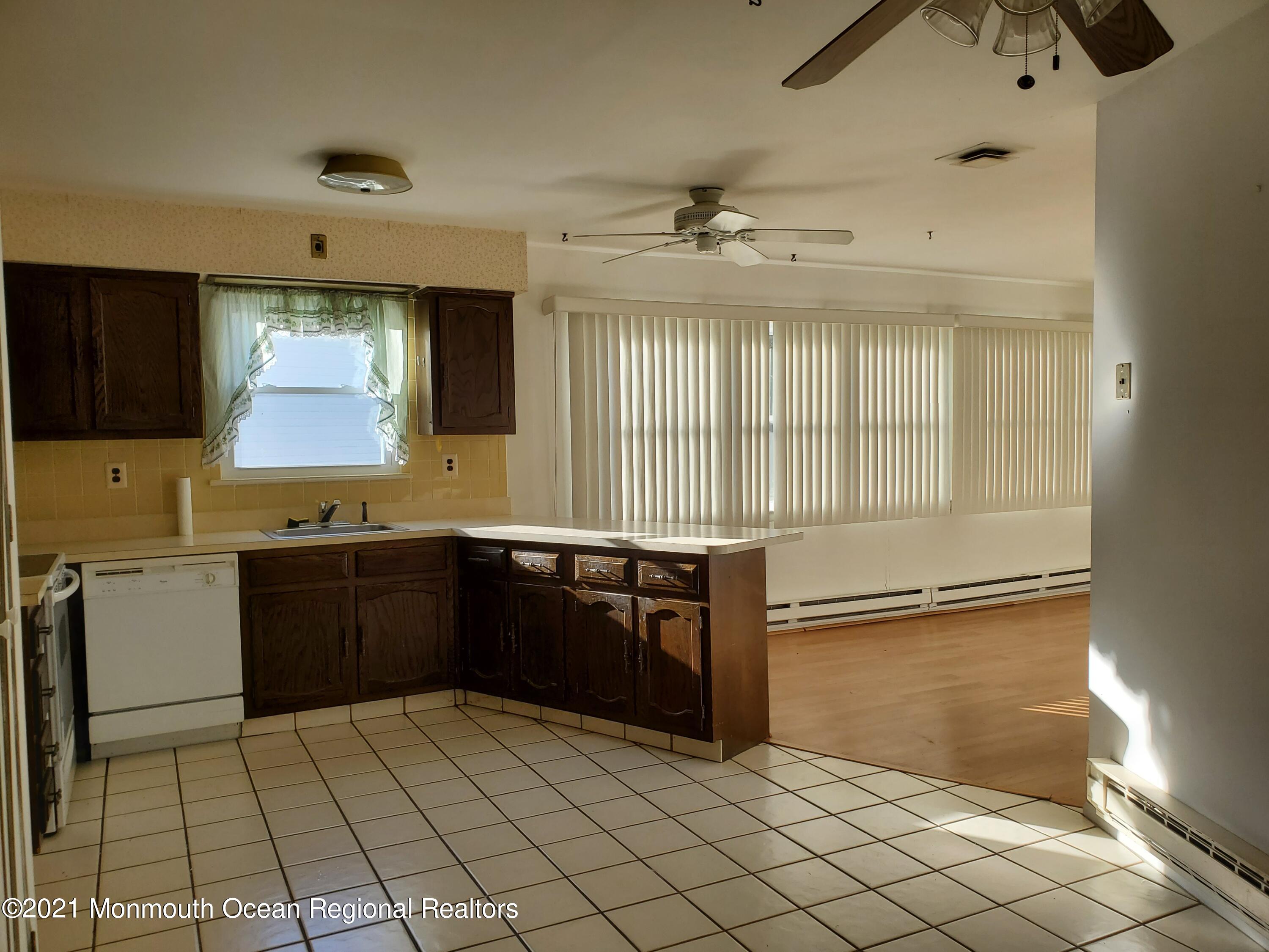 37 Patmore Road Brick, NJ 08724 - Photo 5 of 19 a large kitchen with granite countertop a stove a sink and a microwave