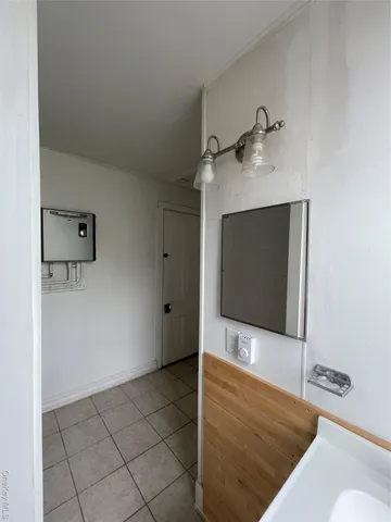 a bathroom with a toilet a sink and a window