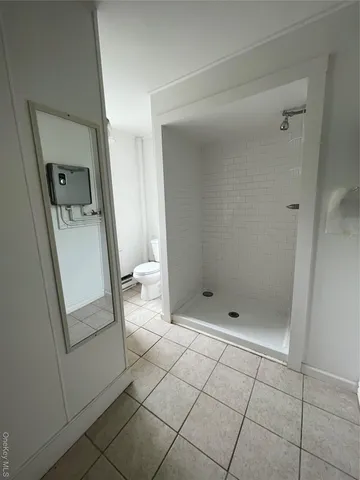 a bathroom with a bathtub sink and mirror