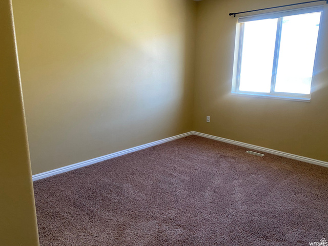 83 Canterbury Circle Logan, UT 84321 - Photo 21 of 23 Spare room with carpet flooring and baseboards