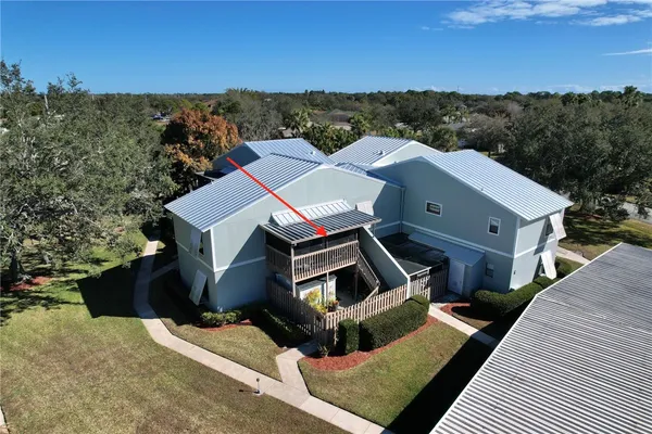 an aerial view of a house with a big yard