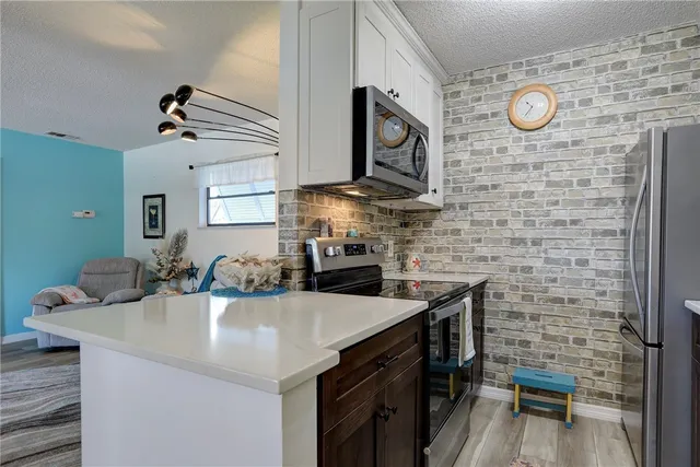a kitchen with stainless steel appliances a sink and cabinets