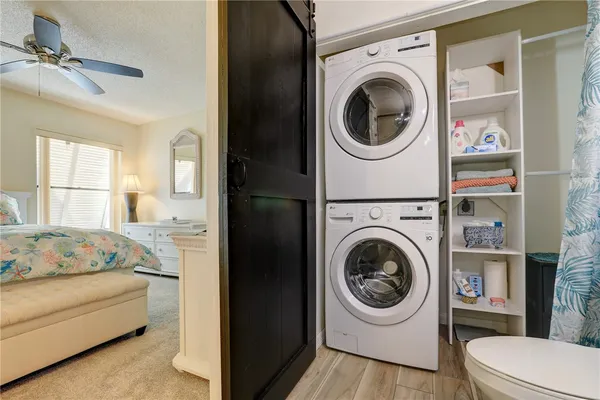 a bedroom with a washer and dryer