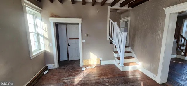a view of entryway and hall with wooden floor