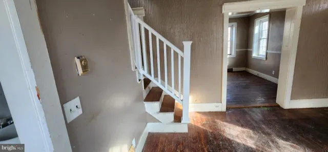 a view of entryway and hall with wooden floor