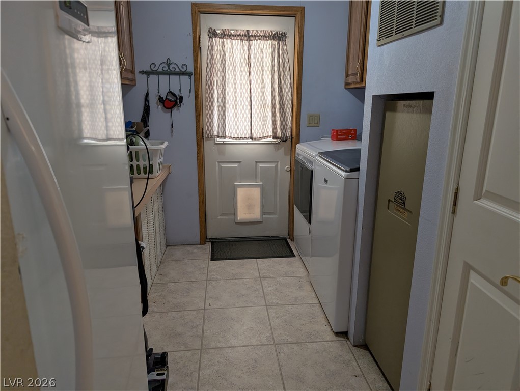 320 6th Street Panaca, NV 89042 - Photo 19 of 31 Laundry area featuring light tile patterned floors and independent washer and dryer
