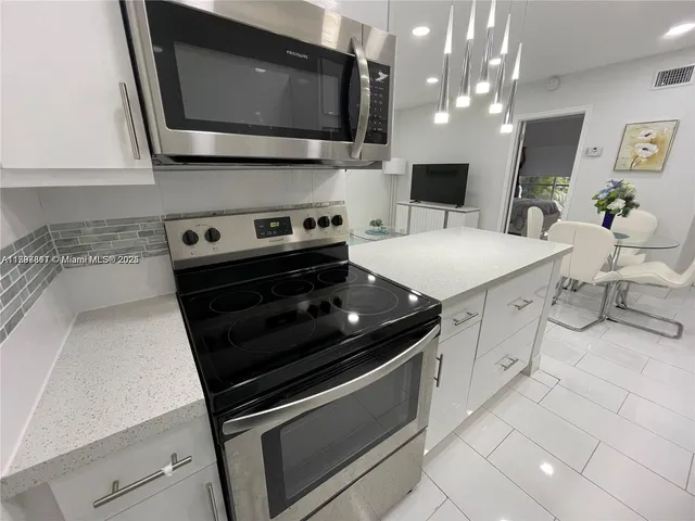 a kitchen with a stove and a microwave