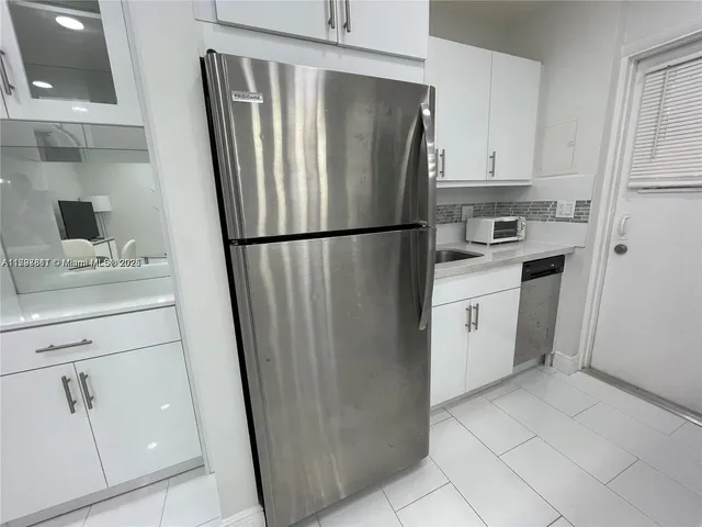 a white refrigerator freezer sitting in a kitchen
