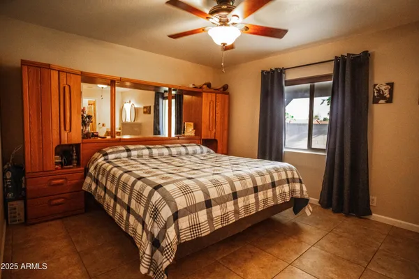 a bed sitting in a bedroom next to a window