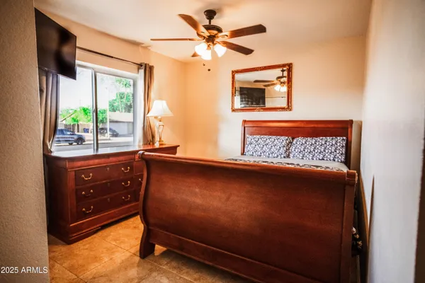 a view of room with window and a ceiling fan