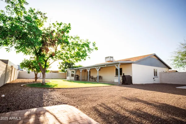 a front view of a house with a yard and trees