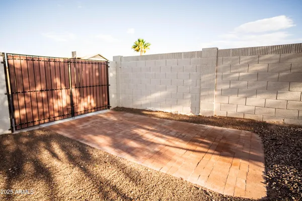 a view of backyard with wooden fence