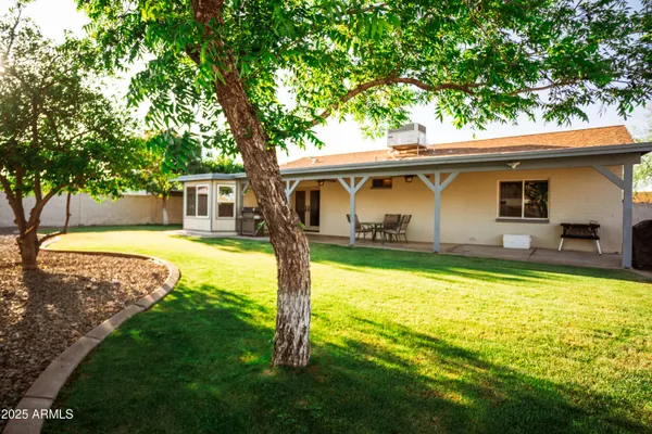 a view of a house with swimming pool and a yard