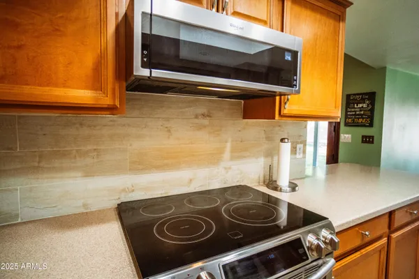 a stove top oven sitting inside of a kitchen