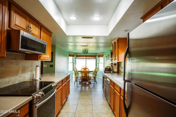 a kitchen with stainless steel appliances granite countertop a sink and a stove