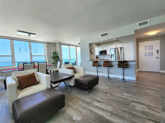 a large kitchen with stainless steel appliances granite countertop a lot of counter space and wooden floors