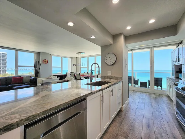 a kitchen with stainless steel appliances granite countertop a stove and a sink