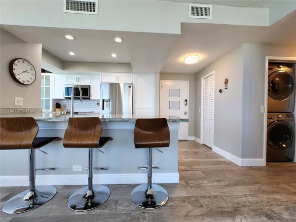 a spacious bedroom with a bed a couch and a window