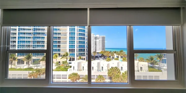a bedroom with a bed and glass windows
