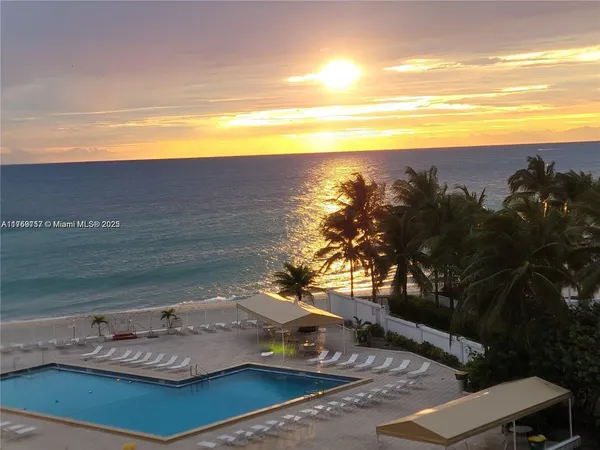 a view of swimming pool with outdoor seating