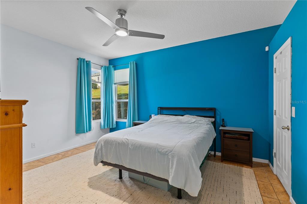 13320 Via Roma Circle Clermont, FL 34711 - Photo 12 of 26 a bedroom with a bed and a large window