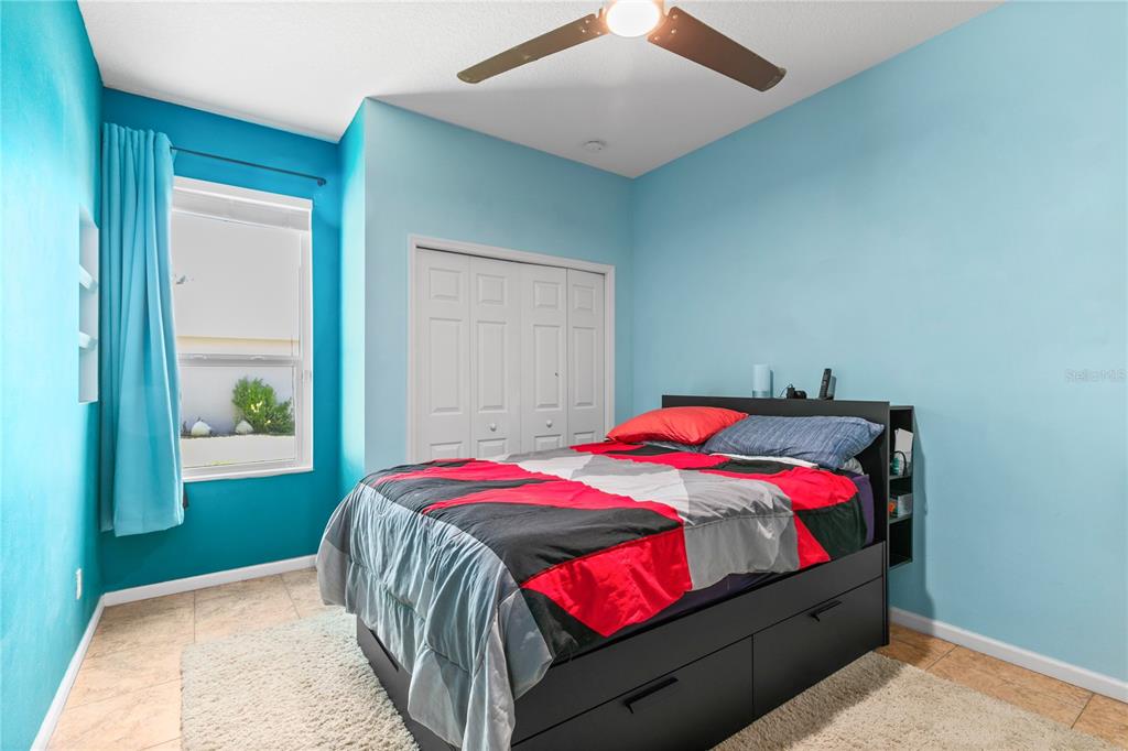 13320 Via Roma Circle Clermont, FL 34711 - Photo 14 of 26 a bedroom with a bed and a window