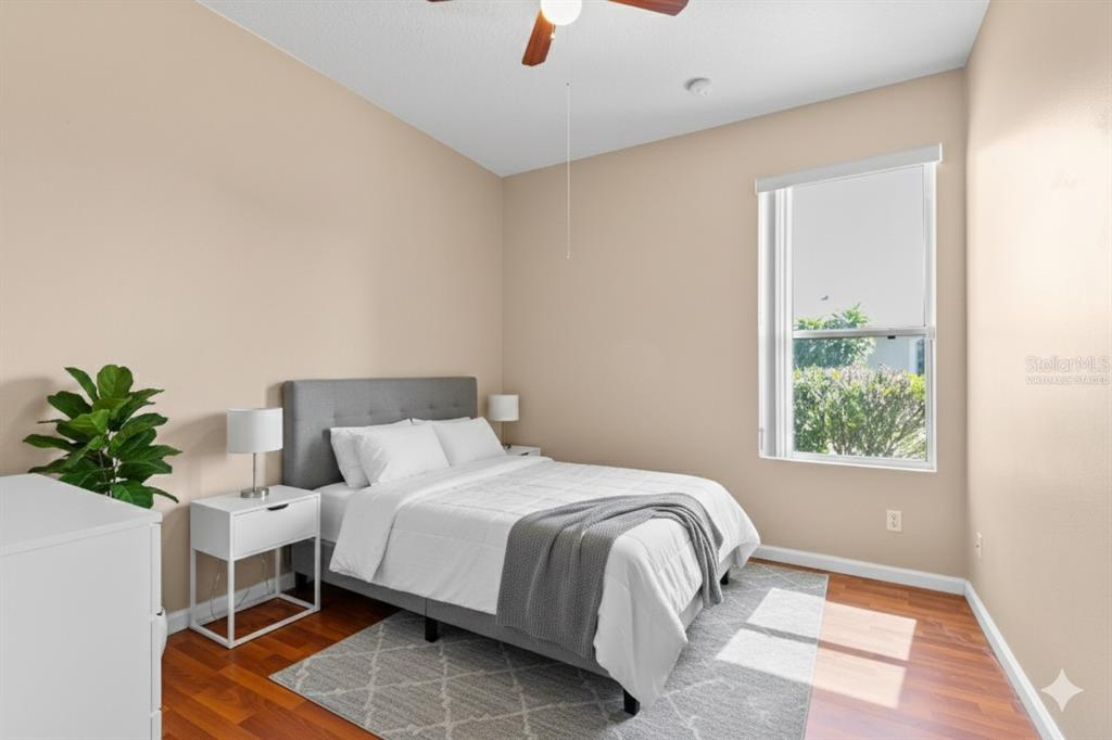 13320 Via Roma Circle Clermont, FL 34711 - Photo 14 of 25 a bedroom with a bed potted plant with the window