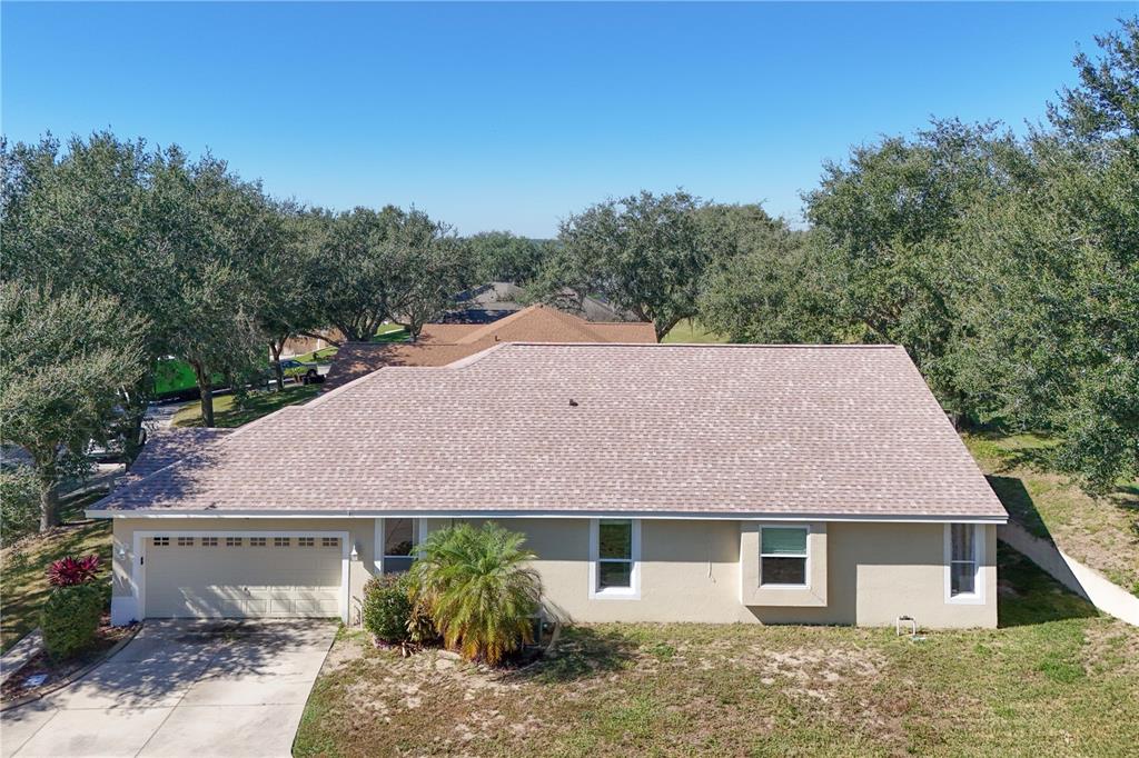 13320 Via Roma Circle Clermont, FL 34711 - Photo 20 of 26 a aerial view of a house with a yard and large tree