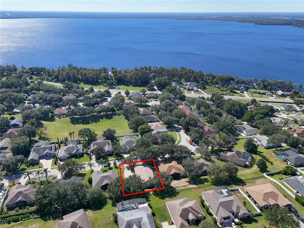 13320 Via Roma Circle Clermont, FL 34711 - Photo 21 of 25 an aerial view of a city with lots of residential buildings and ocean view in back