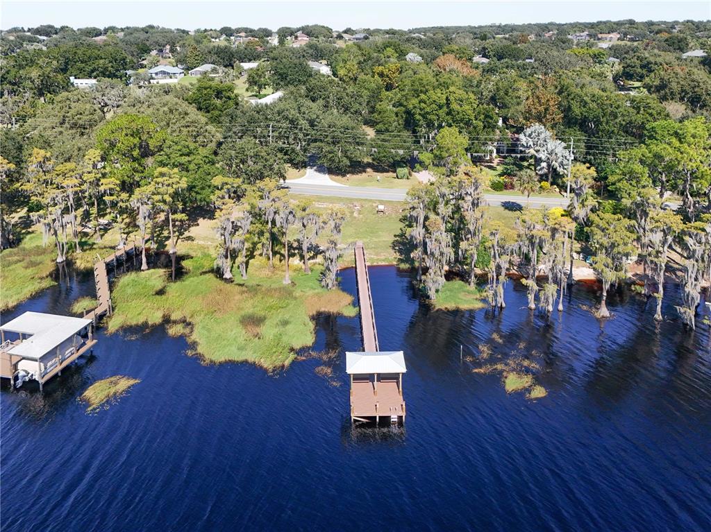 13320 Via Roma Circle Clermont, FL 34711 - Photo 25 of 26 an aerial view of a house with a swimming pool patio and lake view