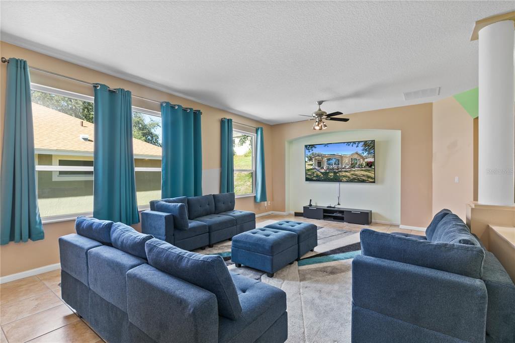 13320 Via Roma Circle Clermont, FL 34711 - Photo 5 of 26 a living room with furniture and a large window