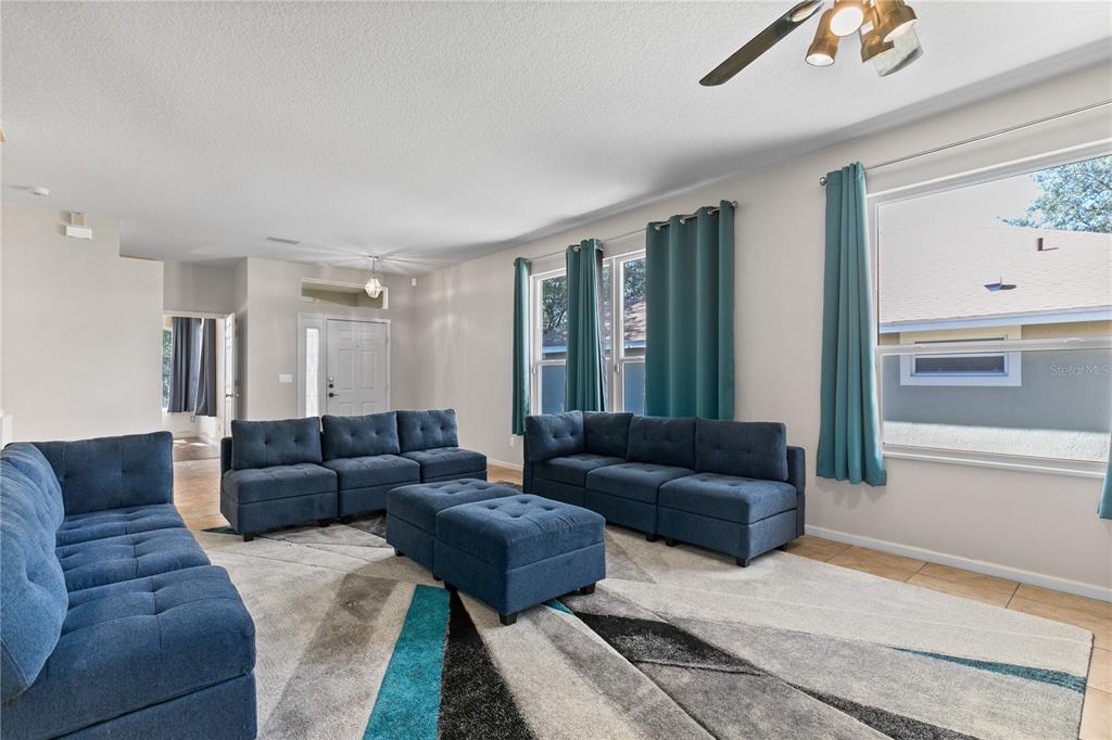 13320 Via Roma Circle Clermont, FL 34711 - Photo 5 of 25 a living room with furniture and a couch