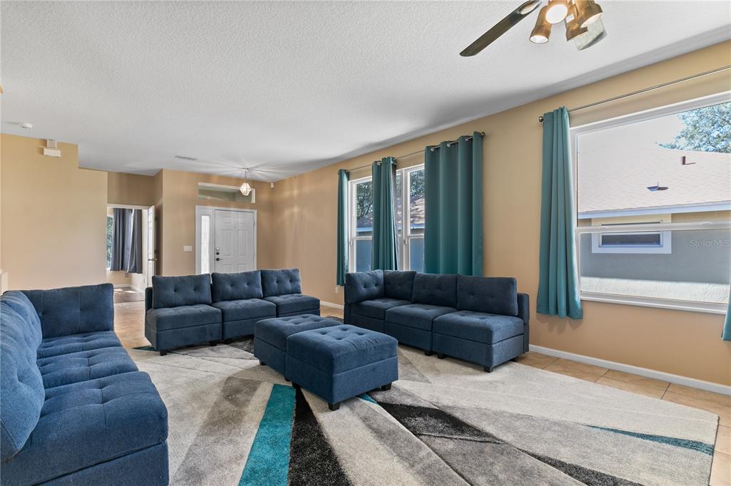 13320 Via Roma Circle Clermont, FL 34711 - Photo 6 of 26 a living room with furniture and a couch