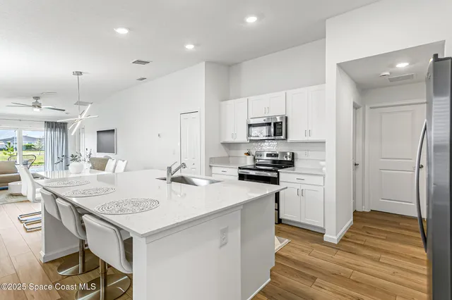 a kitchen with a sink stove and refrigerator