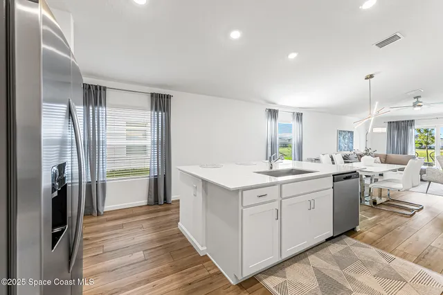 a kitchen with refrigerator a sink and cabinets