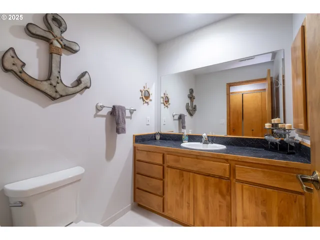 a bathroom with a sink a toilet and mirror