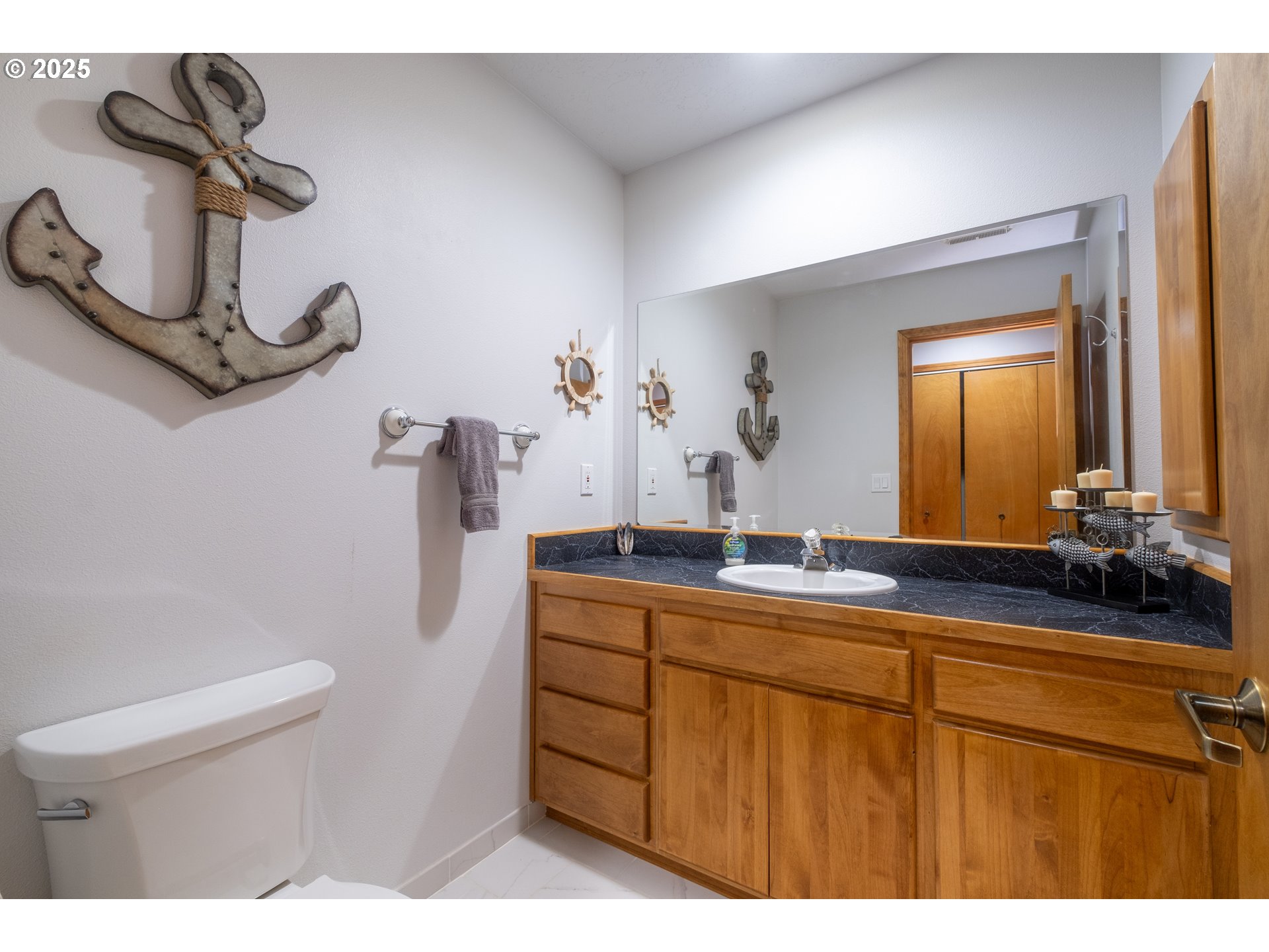 760 Southwest Range Drive Waldport, OR 97394 - Photo 16 of 30 a bathroom with a sink a toilet and mirror