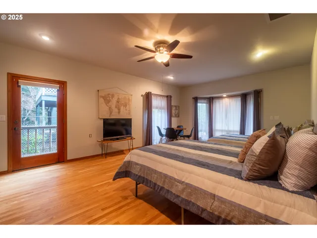 a bedroom with a bed and a ceiling fan