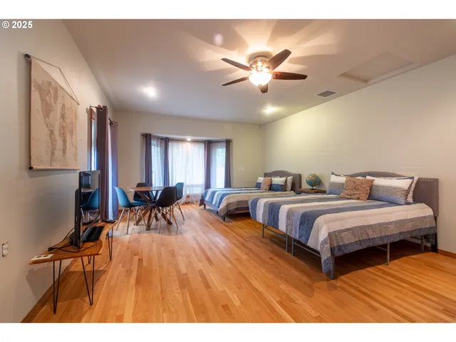 a bedroom with two beds and a chandelier
