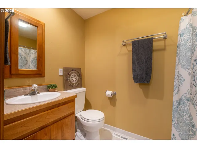 a bathroom with a sink mirror vanity and toilet
