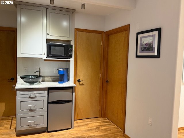 760 Southwest Range Drive Waldport, OR 97394 - Photo 25 of 30 a kitchen with stainless steel appliances granite countertop a refrigerator and a stove